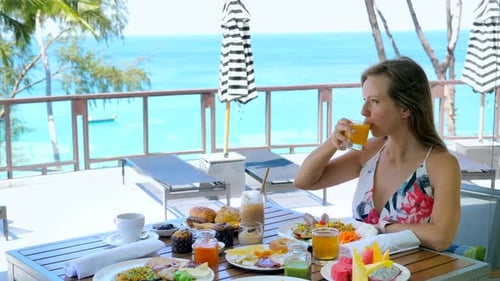 Woman Enjoying Tropical Breakfast with Ocean View