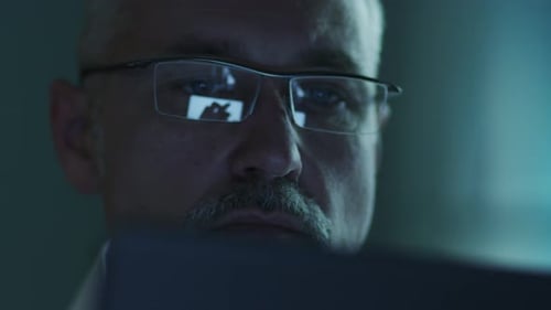 Man Wearing Glasses Concentrating On Computer Screen