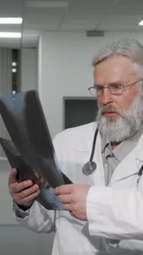Two Male Doctors Analyzing Xray Scans in a Modern Clinic Hallway