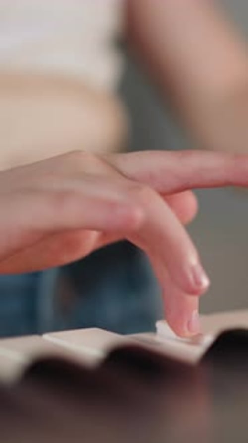 Hand Playing the Piano Keyboard Close-Up
