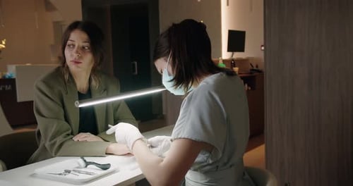 Young Woman Client on Manicure Procedure in Nail Studio