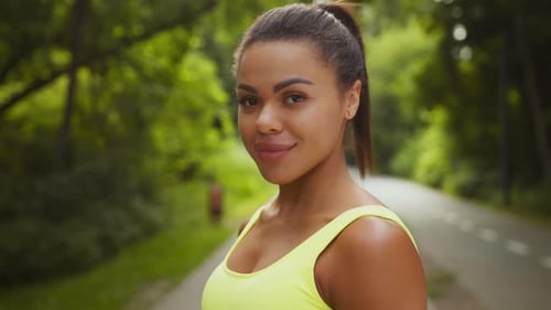 Young African American Woman Jogging in Park Embracing a Healthy Lifestyle