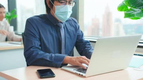 Asian attractive business people wear face mask and working in office.