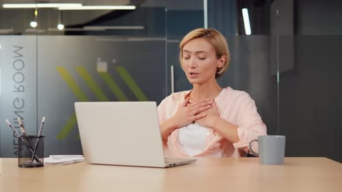Woman Using Laptop for Video Call in Office