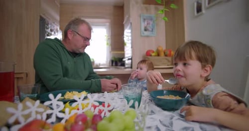Family Together at Breakfast Table Inside Modern Home