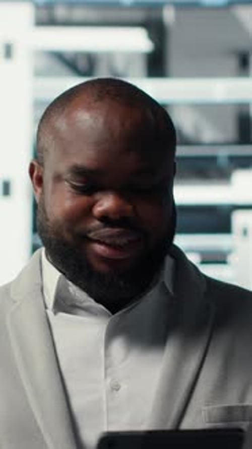 Vertical Video Cheerful Data Center Programmer Using Tablet to Manage Software Updates