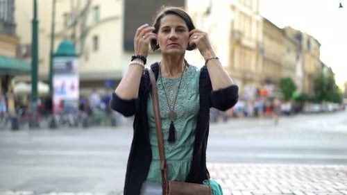 Troubled woman stands pensive on a city street facing difficulties and loneliness