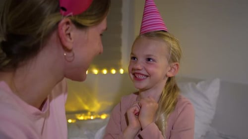 Child Hugs Adult at Happy Birthday Party