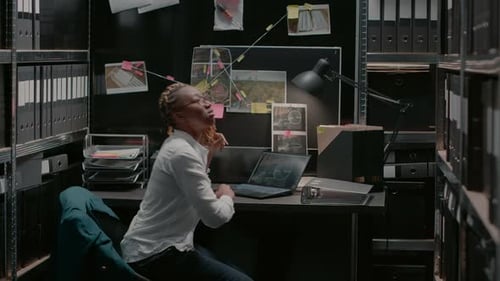 Law Officer Checking Forensic Evidence in Police Office