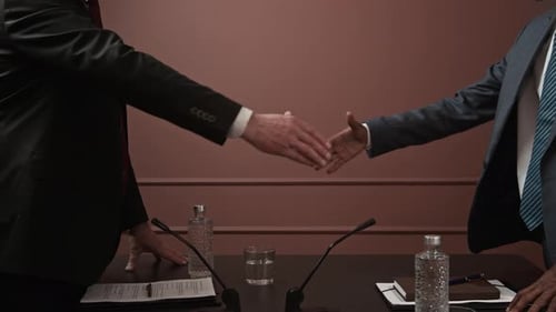 Business People Reach Agreement and Shake Hands