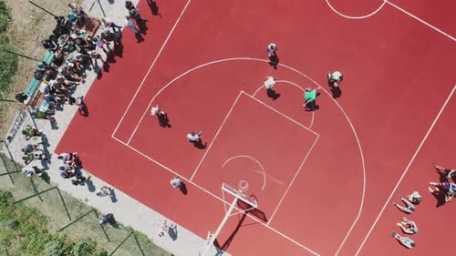 Aerial Top Down View of Teenagers Playing Basketball on the Summer Basketball Court