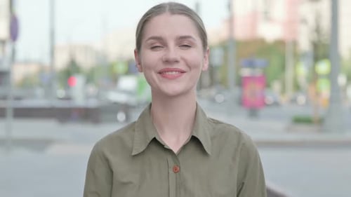 Young Woman Smiling in Urban Environment