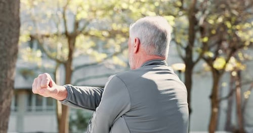 Senior man, nature and stretching arms for warm up, runner and training in park for fitness