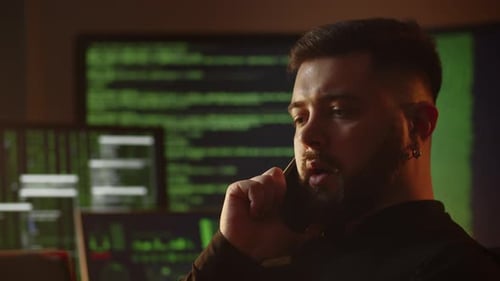 Closeup Shot of a Freelance Programmer Talking on the Phone A Web Programmer is Discussing the