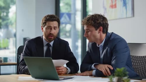 Smiling Colleagues Greeting Laptop Videocall in Modern Office Space Closeup