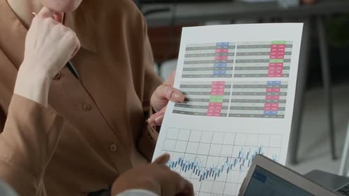 Business Meeting Discussing Financial Charts and Graphs