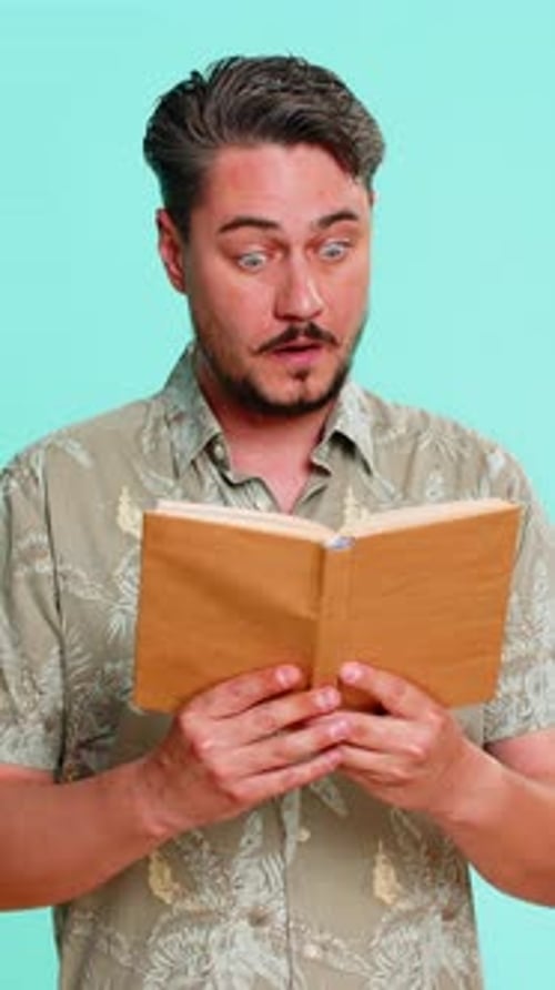 Surprised Man Reads a Book on Blue Background