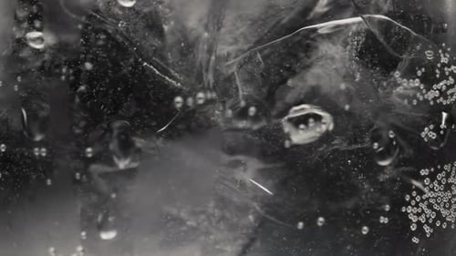 Ice Cubes Bubbling in Glass of Water