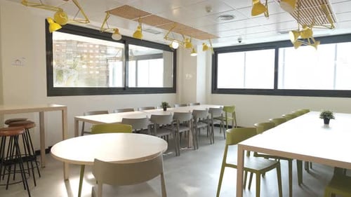 Interior of Office Cafeteria with Tables and Chairs with Glass Windows
