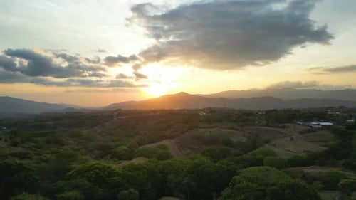 Drone Shot Towards Beautiful Sunset Over Mountains on the Horizon