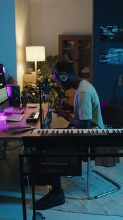 Composer Writing Music Notes on Paper at Home Recording Studio