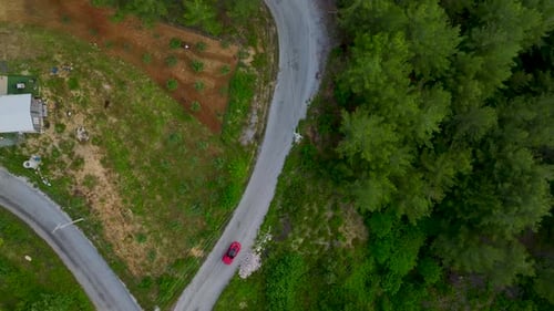 Aerial Video Scenic Drive With Red Convertible Along River Road Bridge