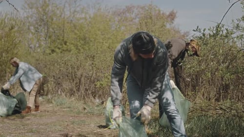 Group of Environmental Volunteers Doing Forest Cleanup