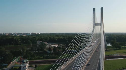 Top view of cable-stayed bridge over river with traffic