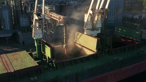 Aerial of Wheat Loading to Bulker Ship Cargo Hold at Sea Grain Elevator in Sea Port Wheat Pouring