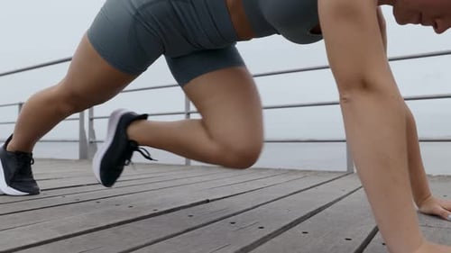 Young Woman Performing Mountain Climber Exercise for Abs