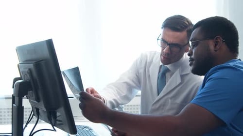Doctor and Surgeon Talking Near Window Medical Workers in Hospital Office Day Light Healthcare