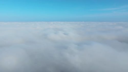 Aerial View Flying Above a Sea of Clouds