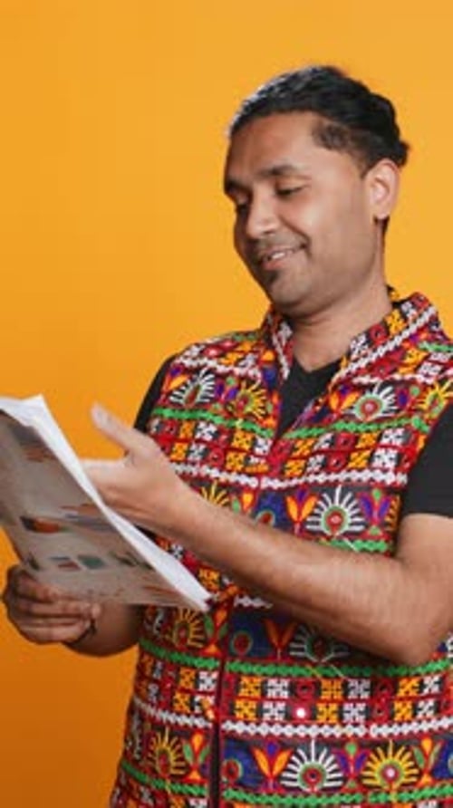 Vertical Video Worker Looking Over Paperwork Graphs Studio Background