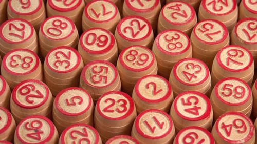 Lotto board game with wooden barrels with numbers close up rotate background. Bingo games
