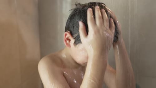 Child Washing Face in Shower