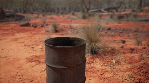 Old Empty Rusted Barrel on Sand