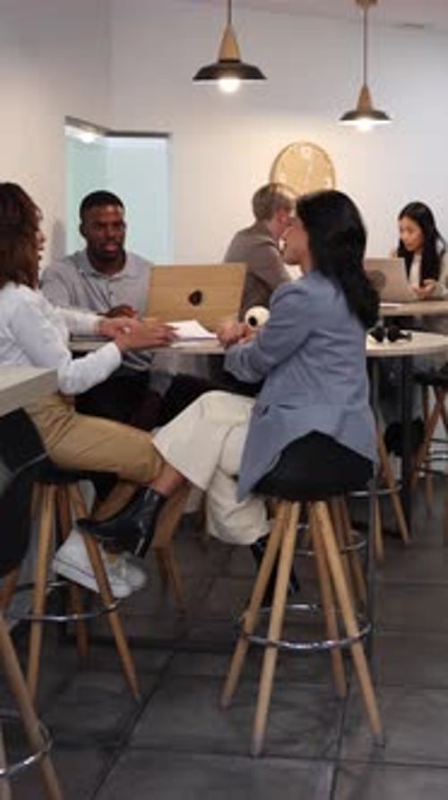 Coworkers discussing business strategy in modern office
