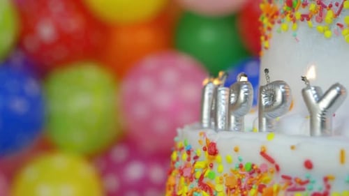 Colorful Birthday Cake with Candles and Balloons