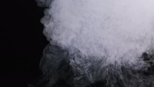 Wispy White Smoke Flowing on Black Background