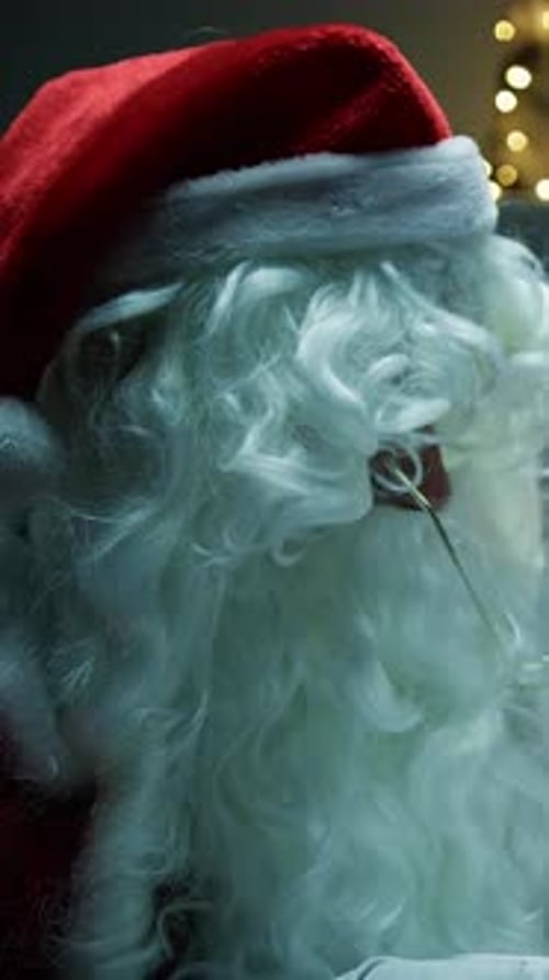 Santa Claus Reads Letter by Christmas Lights