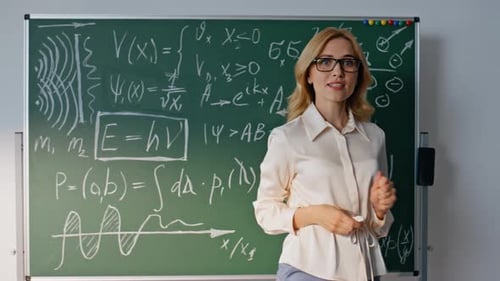 Enthusiastic Educator Explains Complex Equations on Chalkboard