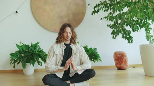 Young Adult Man Meditates in Peaceful Home Setting