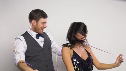 Couple Dancing and Playing with Party Streamers