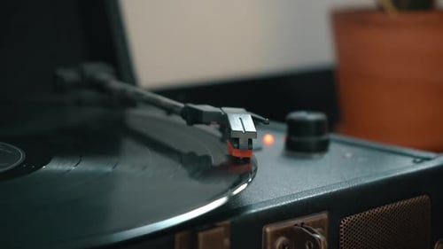 Hand Places Needle on Vintage Record Player