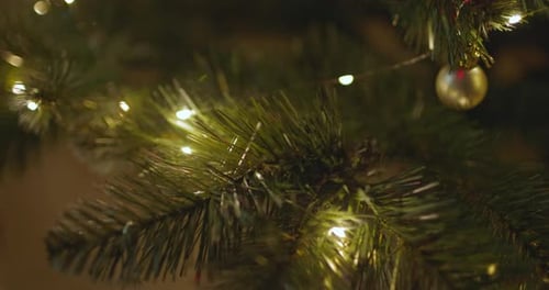 Happy New Year Christmas Tree Decorates on Branch Snow on Background Bokeh of Side Flickering Light