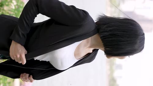 Smiling Woman Poses Confidently Outdoors