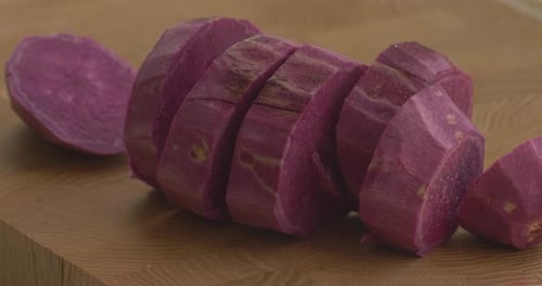Sliced Raw Purple Sweet Potato on Cutting Board