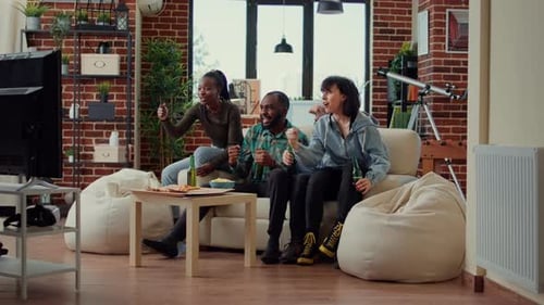 Friends Celebrating While Watching Television in Living Room
