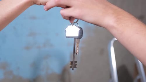 Own Home Mortgage Relocation Concept Couple Hands Holding Key From New First House Family