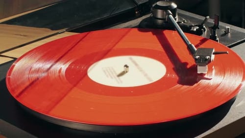 Red Vinyl Record Spinning on Turntable